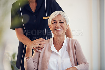 Buy stock photo Cropped shot of an unrecognizable young female nurse caring for a senior woman sitting in a wheelchair in a nursing home