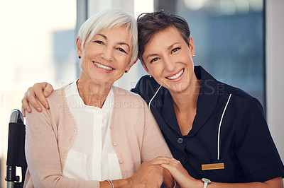 Buy stock photo Cropped portrait of a young female nurse embracing a senior woman sitting in a wheelchair in a nursing home