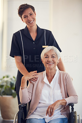 Buy stock photo Cropped portrait of a young female nurse caring for a senior woman sitting in a wheelchair in a nursing home