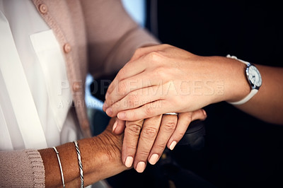 Buy stock photo Cropped shot of an unrecognizable young female nurse holding an aged woman's hands in comfort in a nursing home
