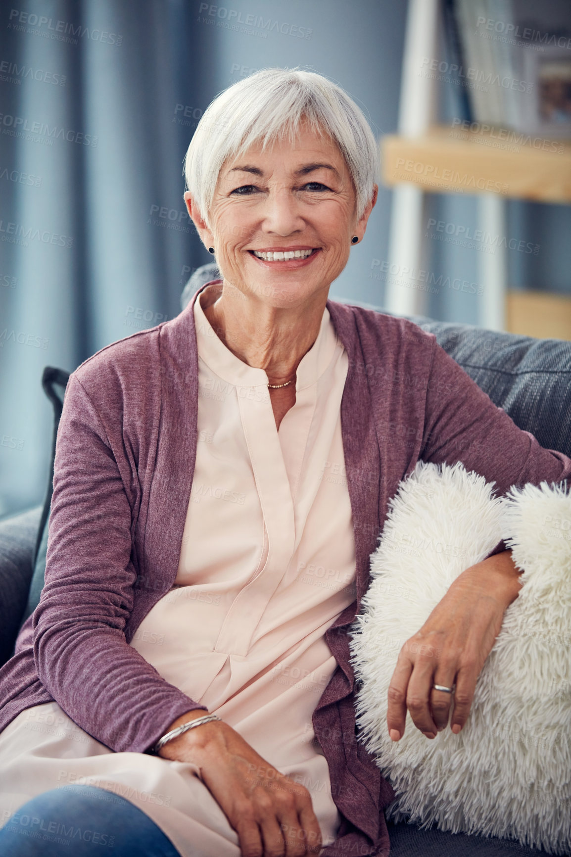 Buy stock photo Cropped portrait of a happy senior woman relaxing comfortably on her couch at home