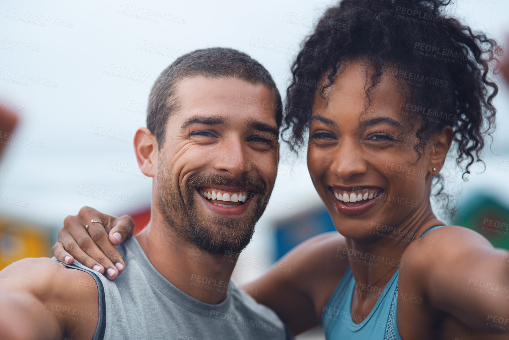 Buy stock photo Portrait of a sporty young couple taking selfies together while exercising outdoors