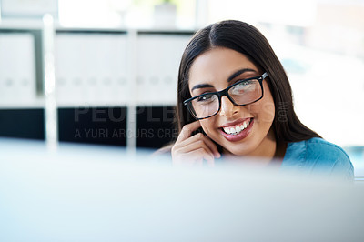 Buy stock photo Portrait of a young businesswoman working on a computer in an office