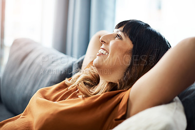 Buy stock photo Cropped shot of a young woman relaxing on the sofa at home