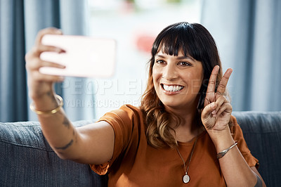 Buy stock photo Woman, house and peace sign on sofa for selfie on break for social media post, interaction and profile picture. Female person, happiness and couch in living room for content creation and photo album