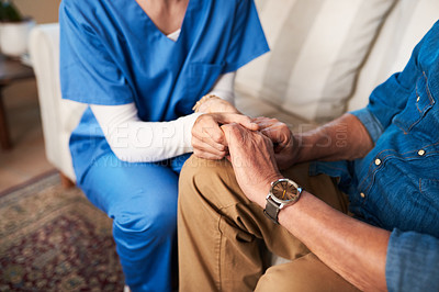 Buy stock photo Cropped shot of a female nurse hold her senior patient's hand