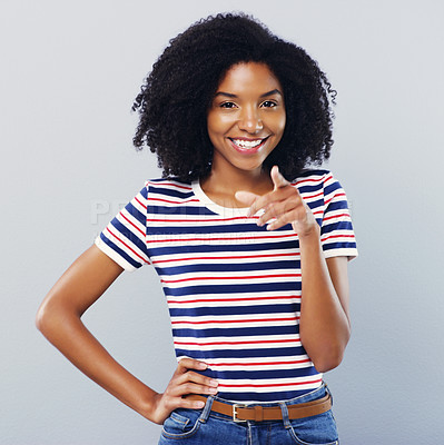 Buy stock photo Studio portrait of an attractive young woman pointing at you against a grey background