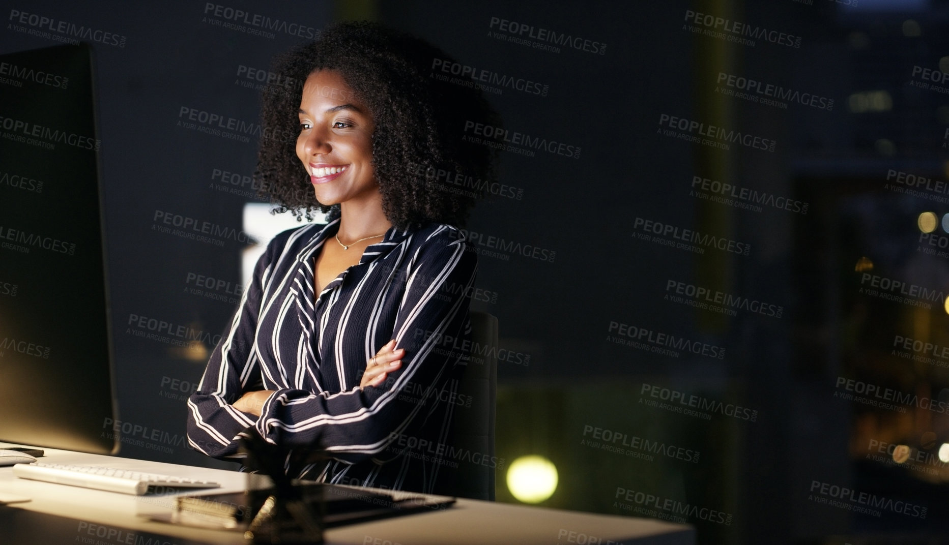 Buy stock photo Cropped shot of an attractive young businesswoman sitting at her desk in the office late at night