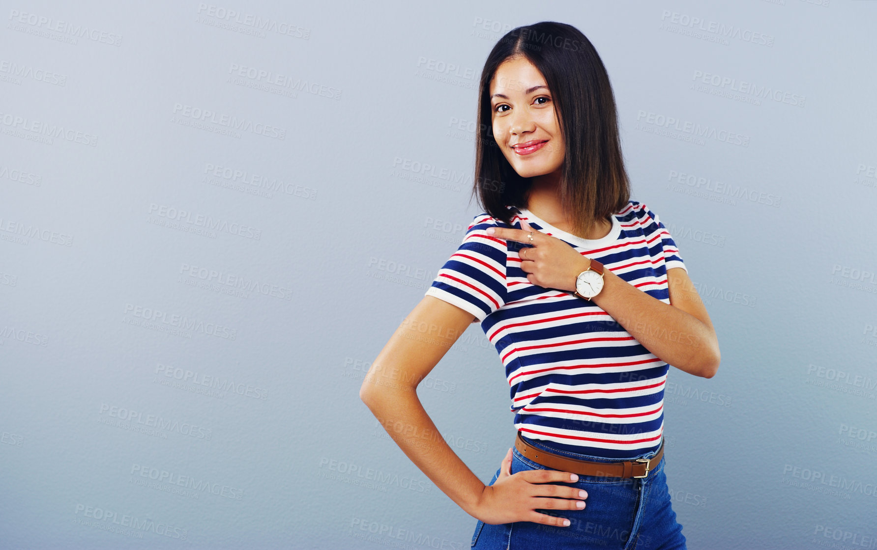 Buy stock photo Studio shot of an attractive young woman pointing at copy space against a grey background