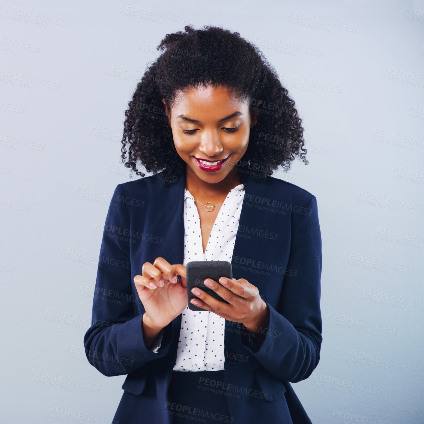 Buy stock photo Studio shot of a beautiful young businesswoman using a smartphone against a grey background