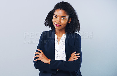 Buy stock photo Studio shot of a confident young businesswoman posing against a grey background