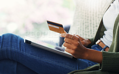 Buy stock photo Cropped shot of an unrecognizable woman using a tablet for online shopping while sitting on the sofa