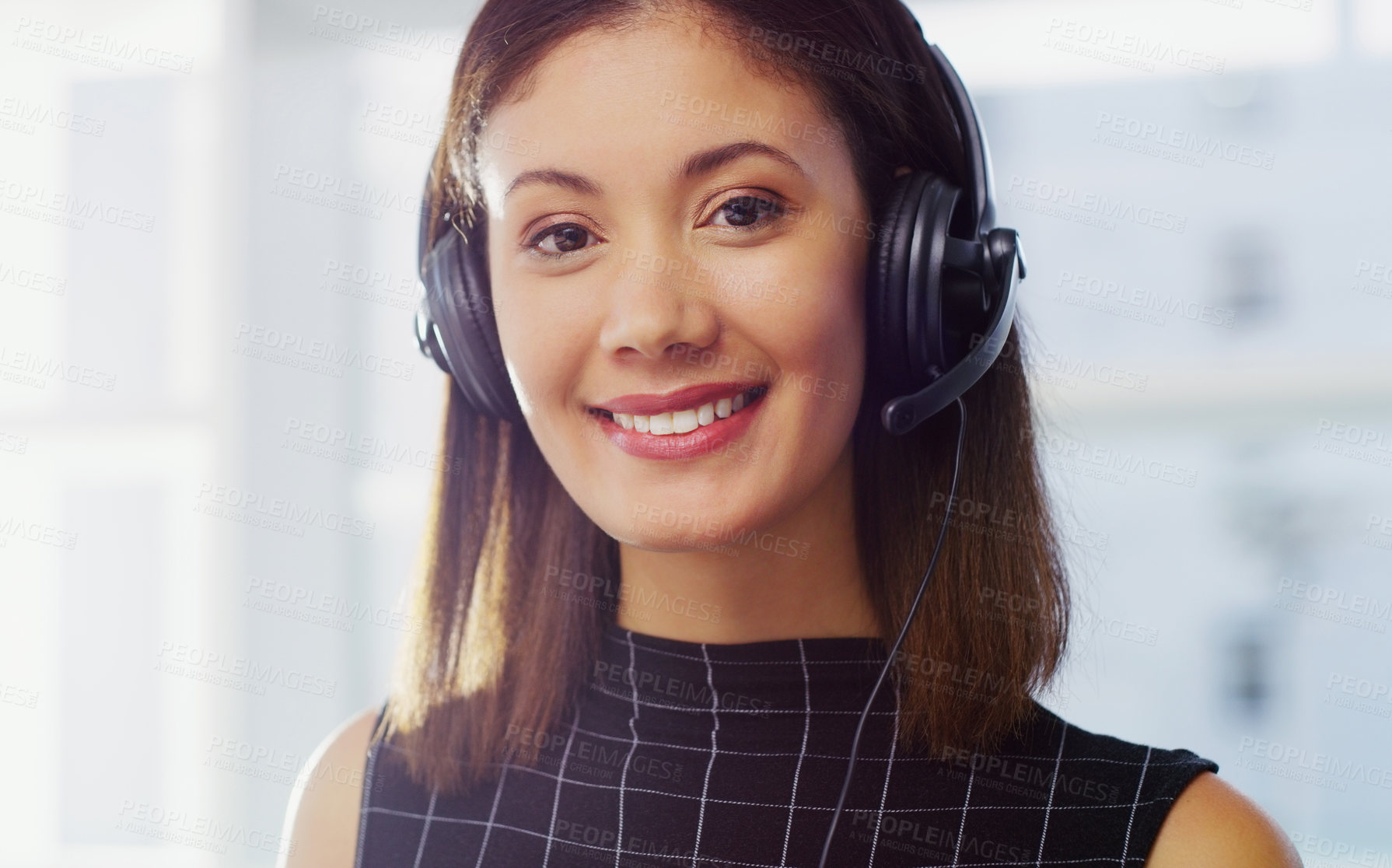 Buy stock photo Cropped portrait of an attractive young businesswoman wearing a headset while in the office during the day
