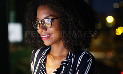 Buy stock photo Cropped shot of a young attractive businesswoman wearing glasses and working while in the office late at night