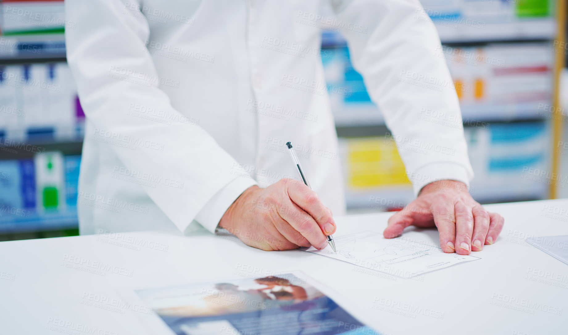 Buy stock photo Cropped shot of an unrecognizable pharmacist on a page
