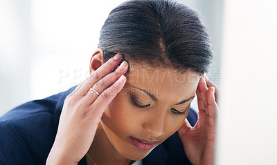 Buy stock photo Shot of a young businesswoman experiencing stress while working in a modern office