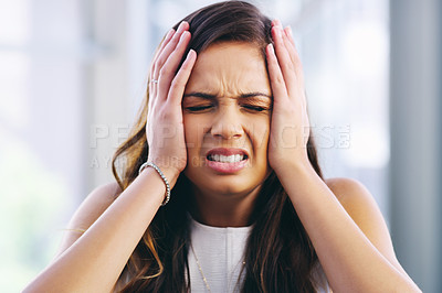 Buy stock photo Shot of a young businesswoman experiencing stress while working in a modern office