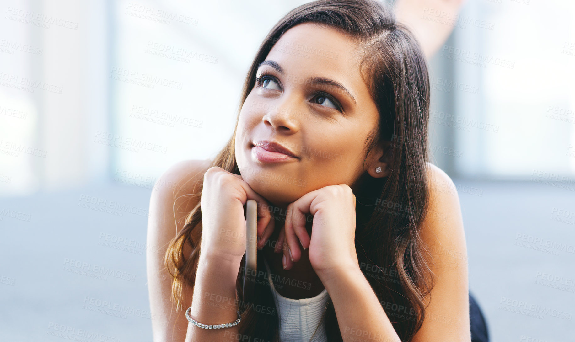 Buy stock photo Shot of a young woman laying on the floor and daydreaming