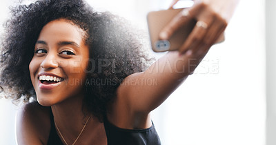 Buy stock photo Shot of a confident young woman taking a selfie with her smartphone