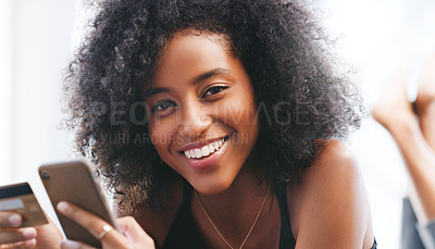 Buy stock photo Shot of a young woman using a credit card and smartphone