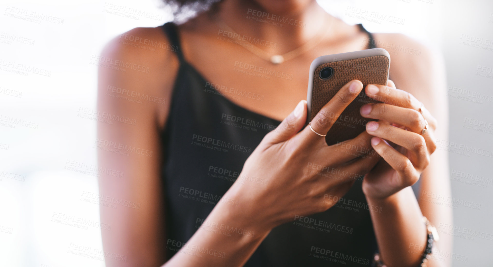 Buy stock photo Cropped shot of a woman using a smartphone