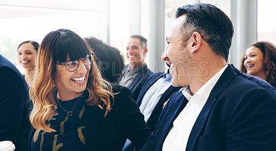 Buy stock photo Shot of a group of businesspeople laughing while attending a conference