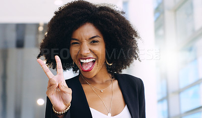 Buy stock photo Portrait of a confident young businesswoman showing a peace gesture in a modern office