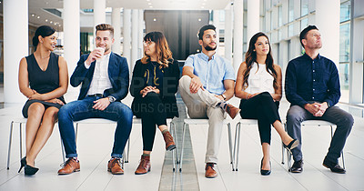 Buy stock photo Shot of a group of diverse businesspeople waiting in line in a modern office