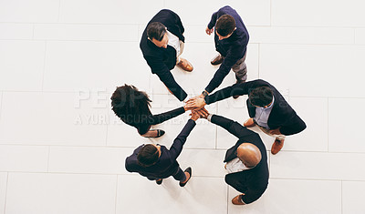 Buy stock photo High angle shot of a group of businesspeople joining their hands in solidarity