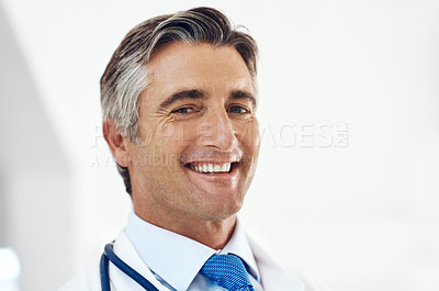 Buy stock photo Cropped portrait of a handsome mature male doctor standing in the hospital
