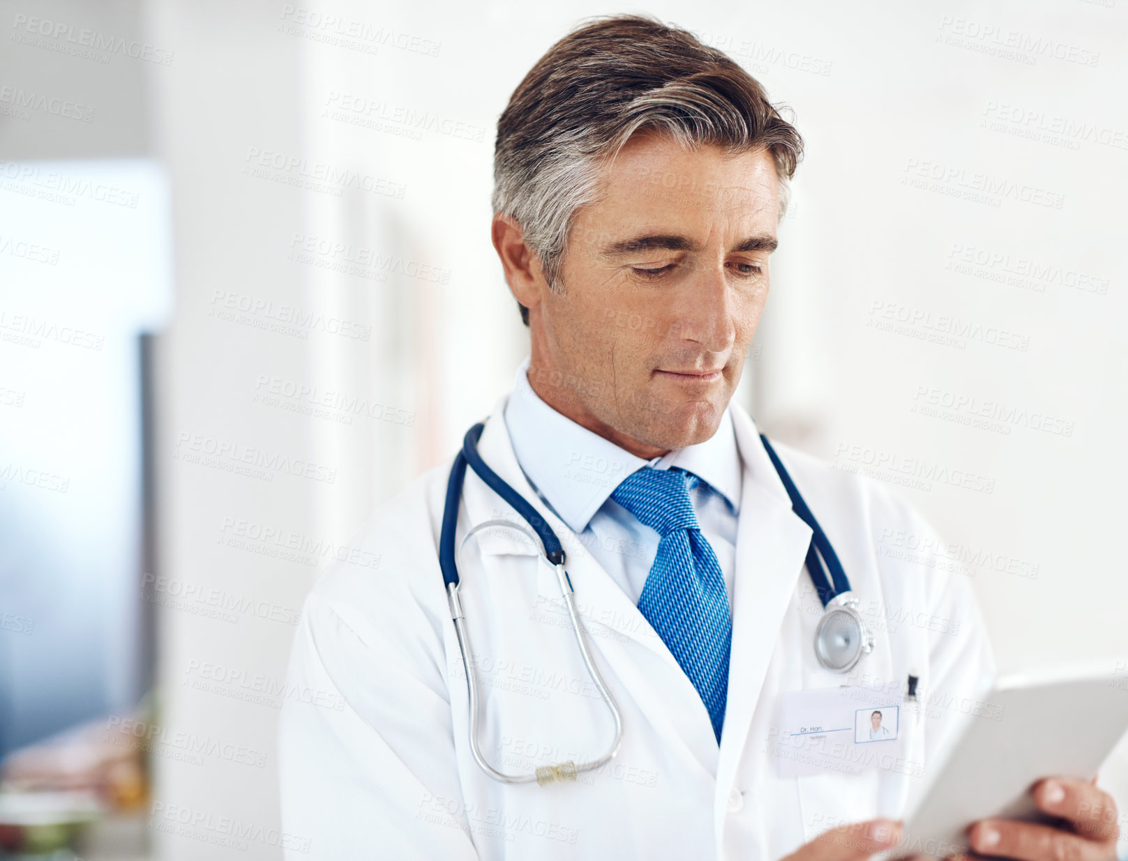 Buy stock photo Doctor, man and reading on tablet for healthcare, information or telehealth in hospital. Digital technology, medical professional and research report on internet for email or clinic results on app