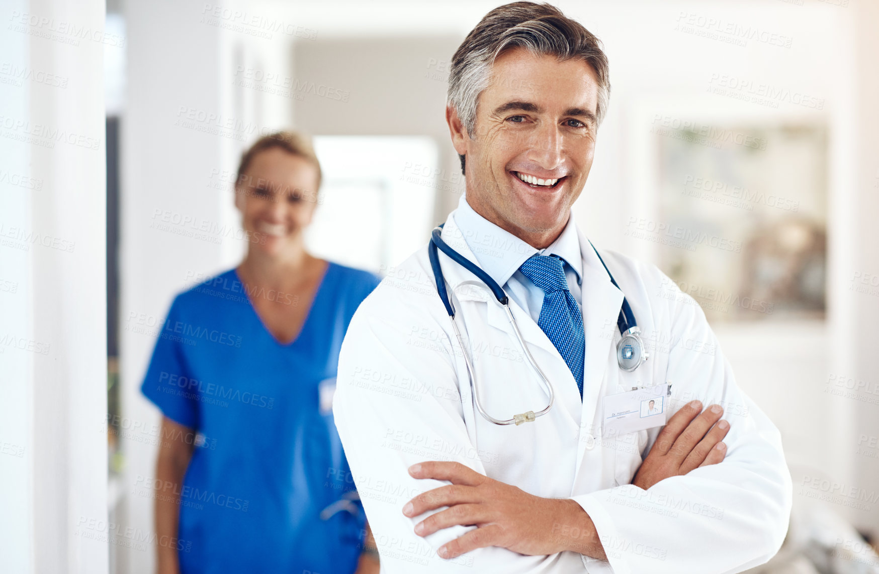 Buy stock photo Senior doctor, man and happy with arms crossed for health, advice and portrait at hospital. Person, staff and smile with pride for career in wellness, care and confidence at clinic in Switzerland