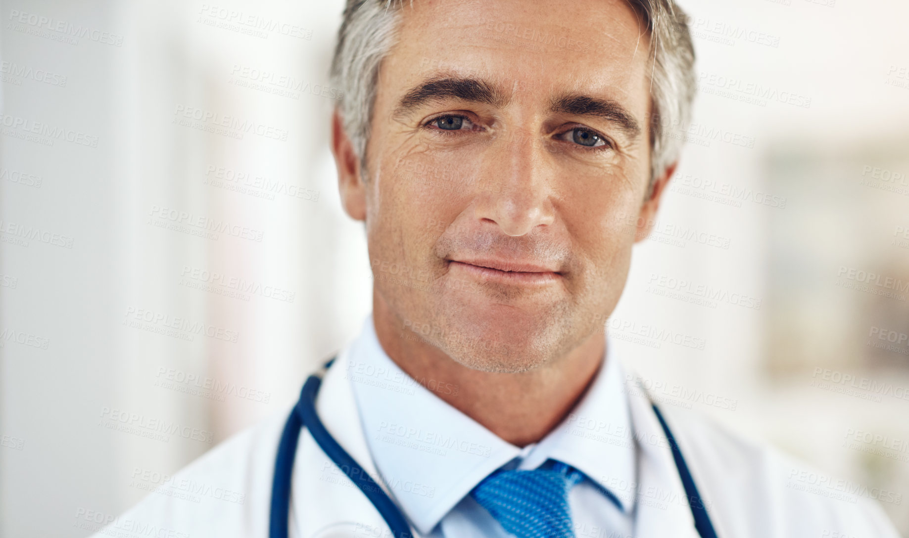 Buy stock photo Mature doctor, man and portrait in hospital for healthcare, advice and consulting services. Person, medic and smile with pride for career with wellness, care and confidence at clinic in Switzerland