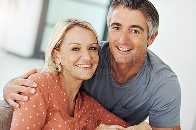 Buy stock photo Cropped portrait of an affectionate mature couple relaxing on the sofa at home