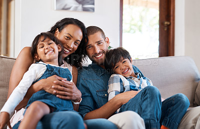 Buy stock photo Cropped shot of a family of four sitting together on the sofa at home
