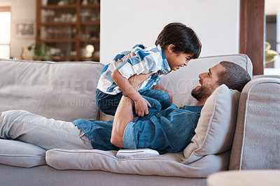Buy stock photo Shot of a man spending quality time with his young son at home