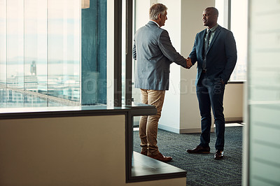 Buy stock photo Full lengths shot of two businessmen shaking hands in an office
