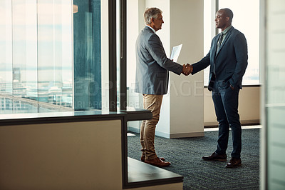 Buy stock photo Full lengths shot of two businessmen shaking hands in an office