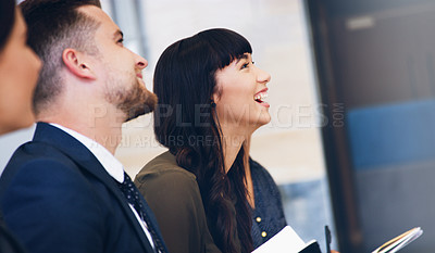 Buy stock photo Cropped shot of an attractive young businesswoman sitting with her colleagues while in the office during the day