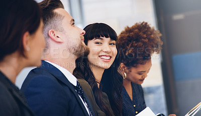 Buy stock photo Cropped shot of an attractive young businesswoman sitting with her colleagues while in the office during the day