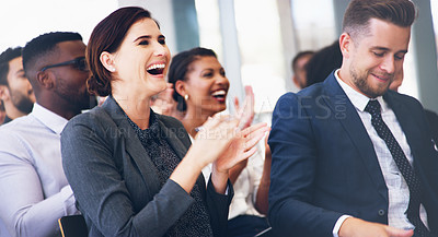 Buy stock photo Cropped shot of an attractive young businesswoman sitting with her colleagues and clapping while in the office during the day