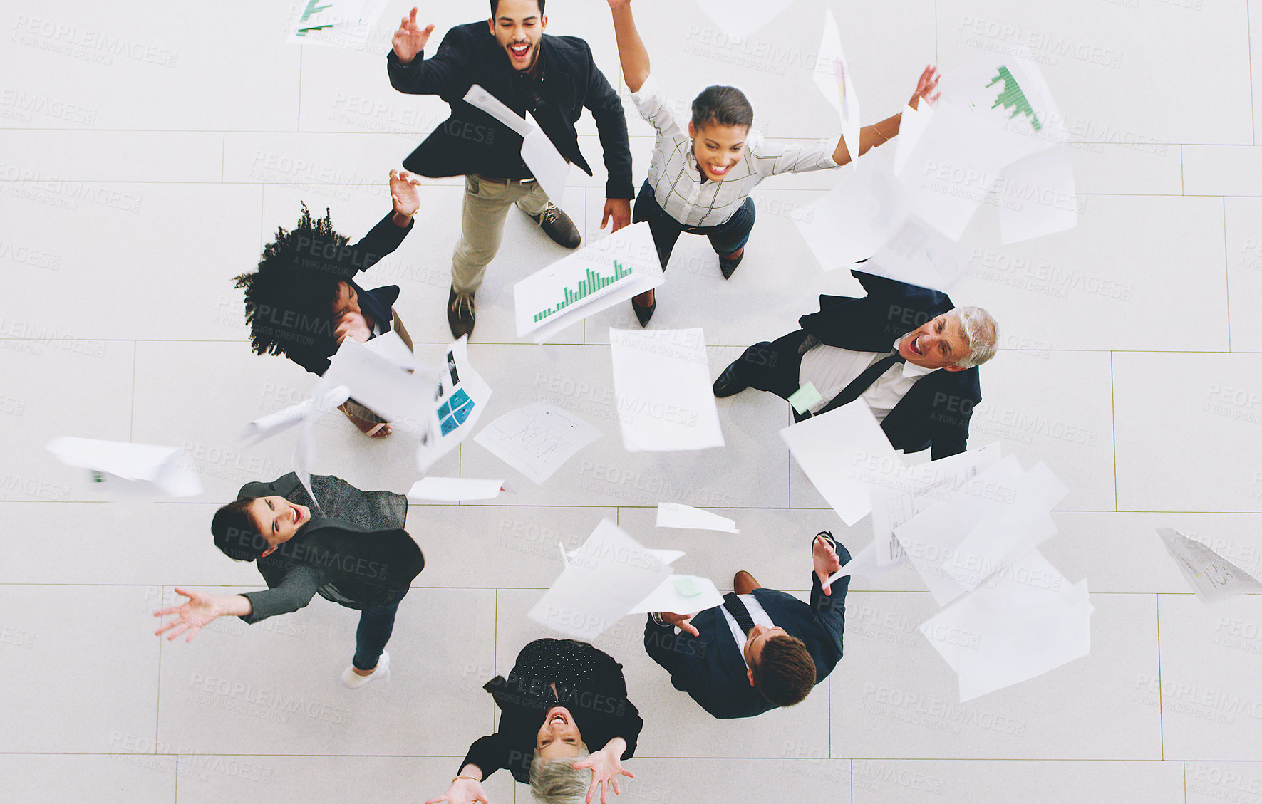 Buy stock photo Aerial shot of a diverse group of businesspeople throwing paperwork in the air in celebration while in the office