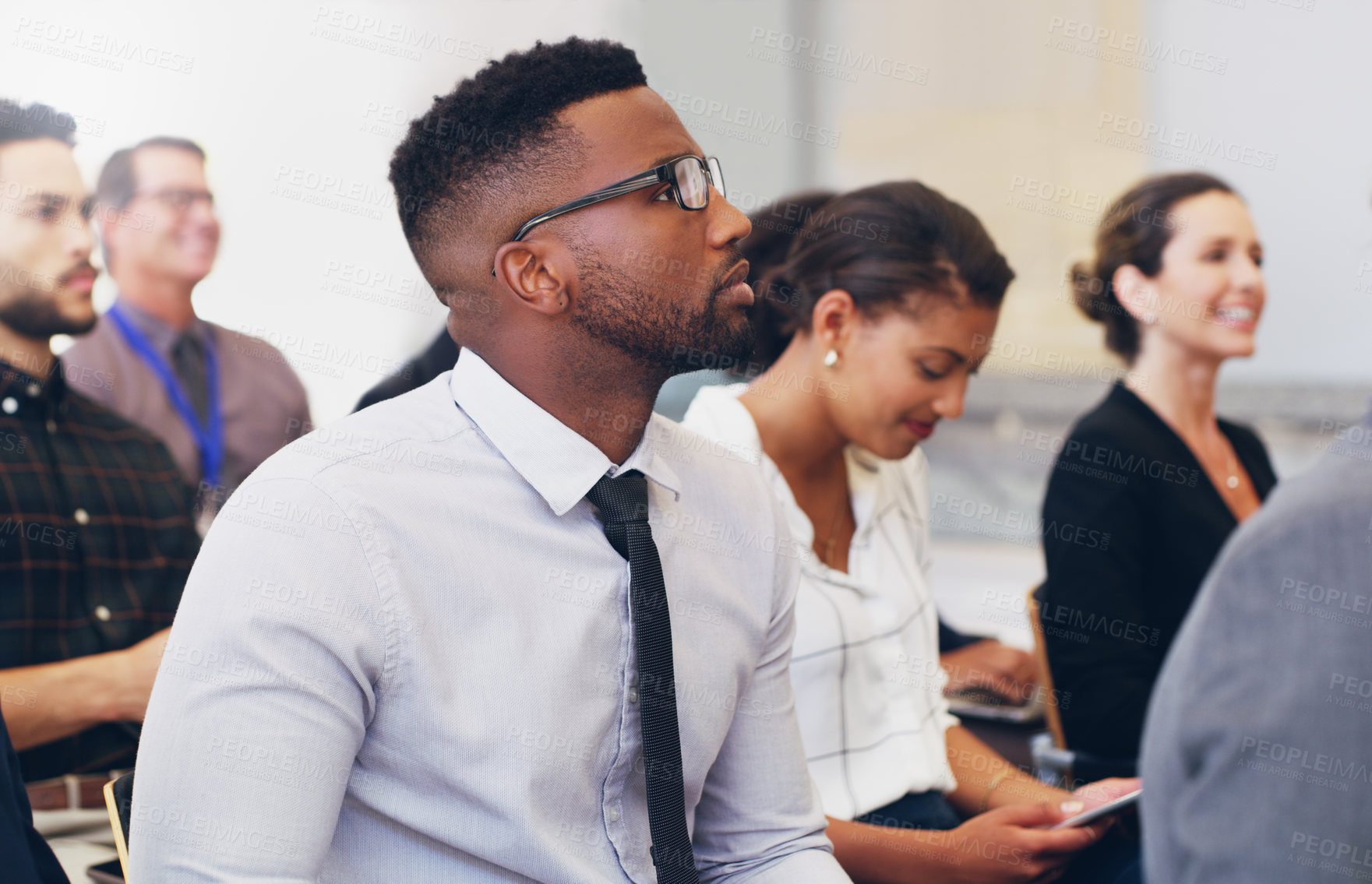 Buy stock photo Presentation, conference or black man in seminar learning, research or business meeting with colleagues. Businessman, training or employee and team for marketing, advertising or innovation strategy