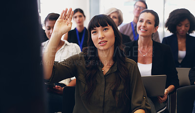 Buy stock photo Cropped shot of an attractive young businesswoman sitting with her diverse colleagues and raising her hand while in the office