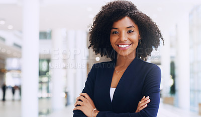 Buy stock photo Cropped portrait of an attractive young businesswoman smiling and standing in the office with her arms crossed during the day