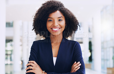 Buy stock photo Cropped portrait of an attractive young businesswoman smiling and standing in the office with her arms crossed during the day
