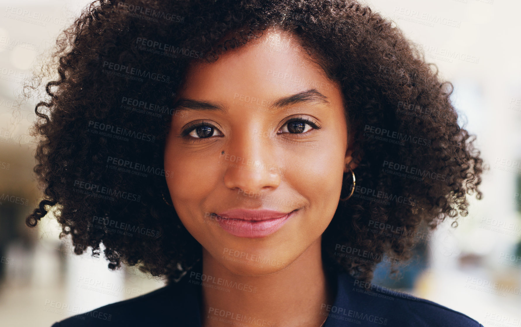 Buy stock photo Cropped portrait of an attractive young businesswoman smiling and standing in the office during the day