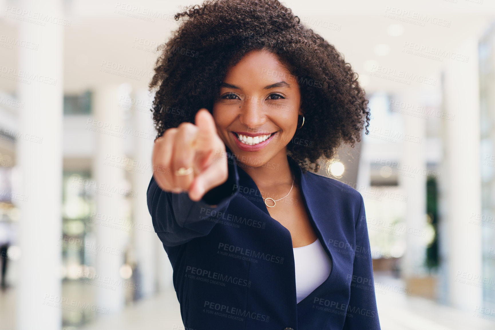 Buy stock photo Cropped portrait of an attractive young businesswoman standing and pointing while in the office during the day