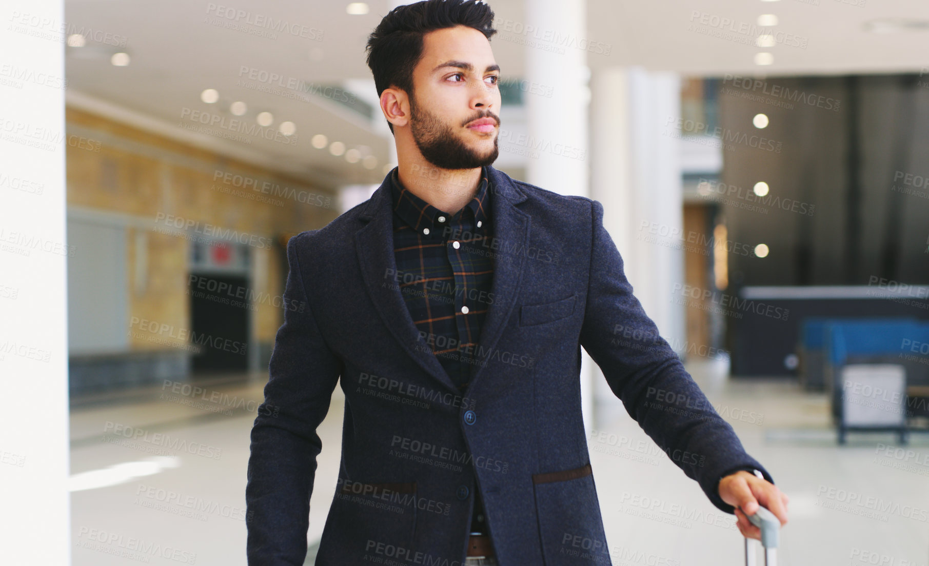 Buy stock photo Cropped shot of a handsome young businessman standing and looking away while in the office during the day