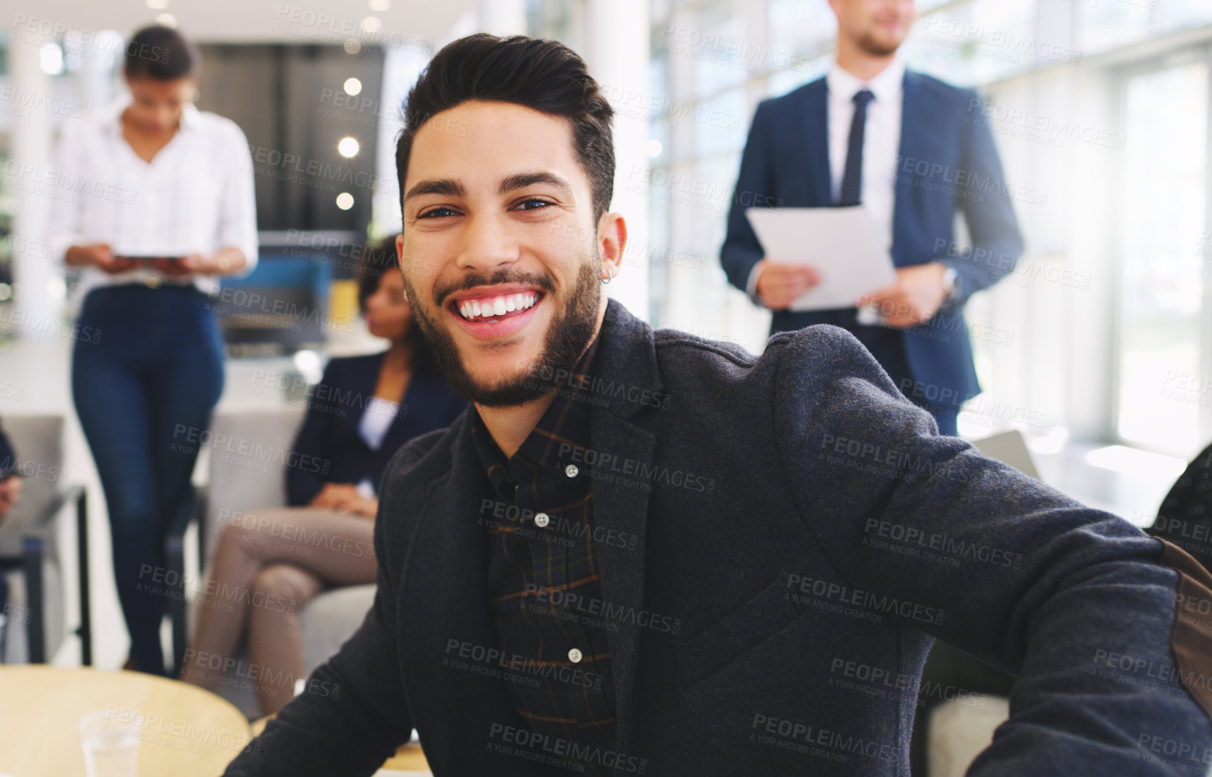 Buy stock photo Portrait, meeting and strategy with a business man sitting in the office with his team or colleague group. Face, marketing and smile wth a happy male employee working with his staff for planning